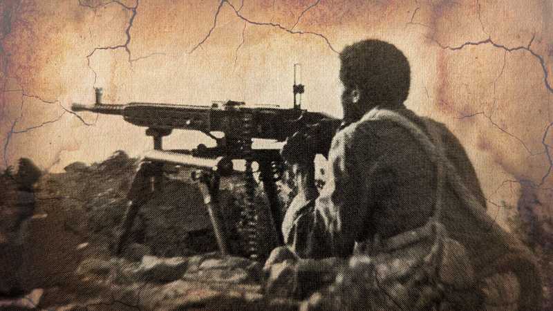 EPLF freedom fighter defending with a machine gun from the trenches