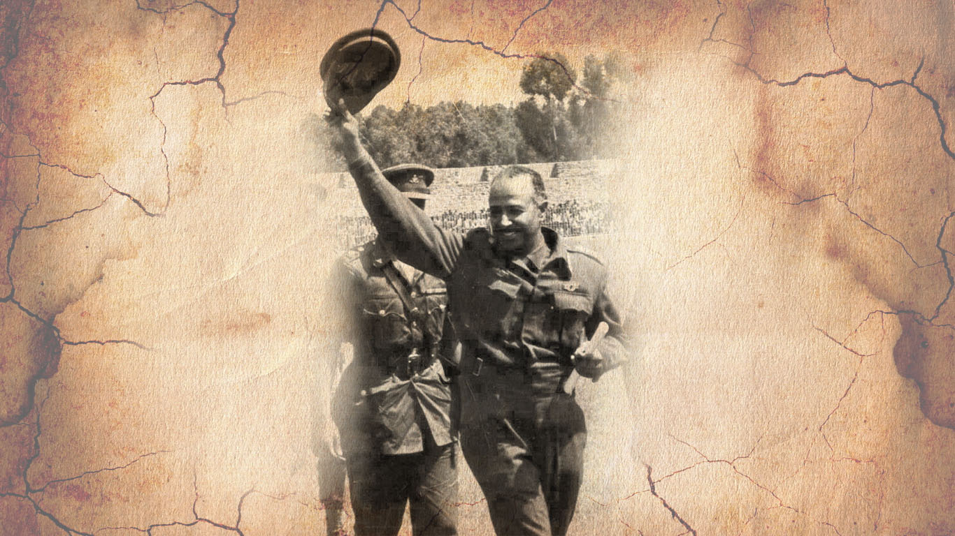 General Aman Andom waving at a crowd in a stadium